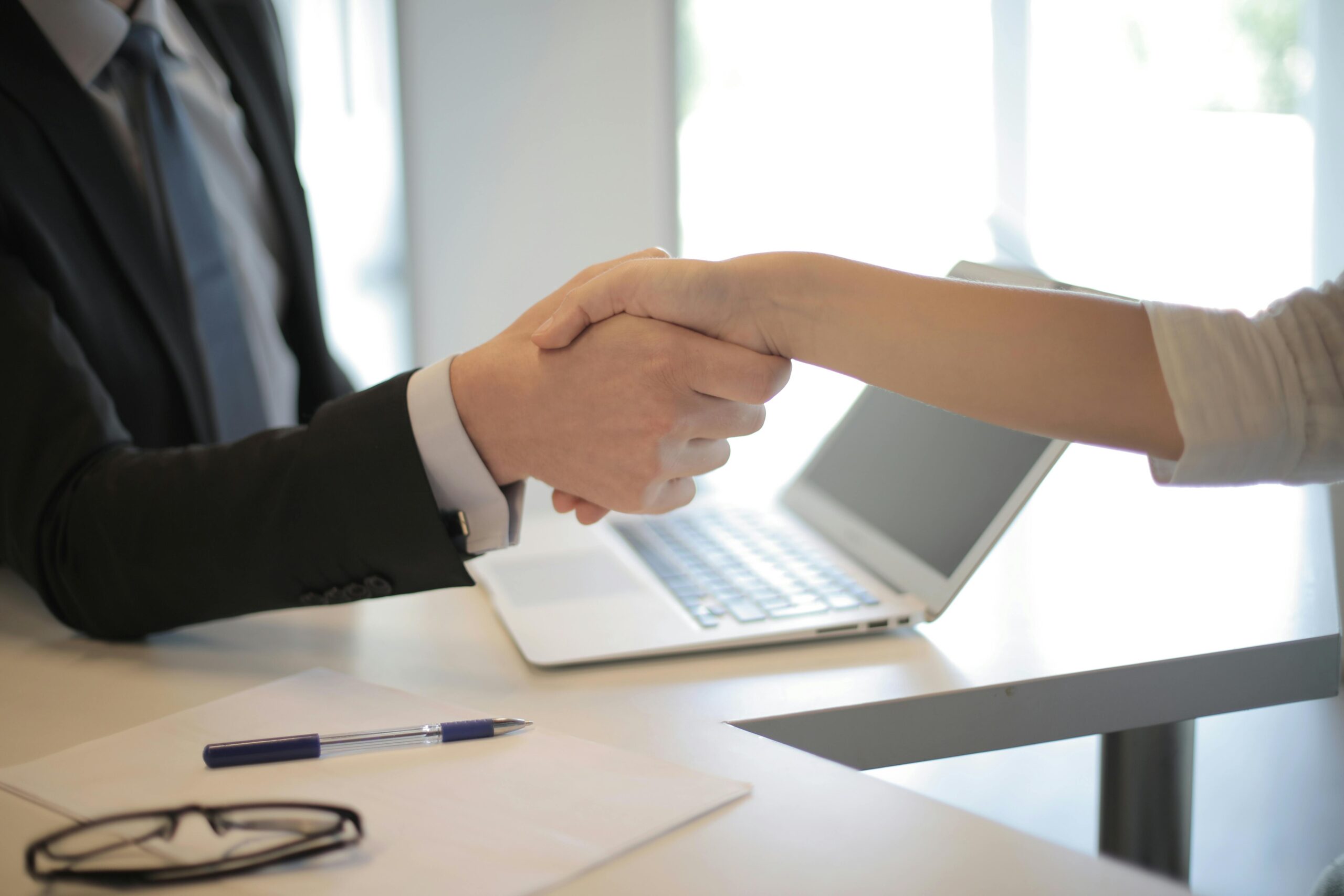 handshake after getting hired for a marketing role